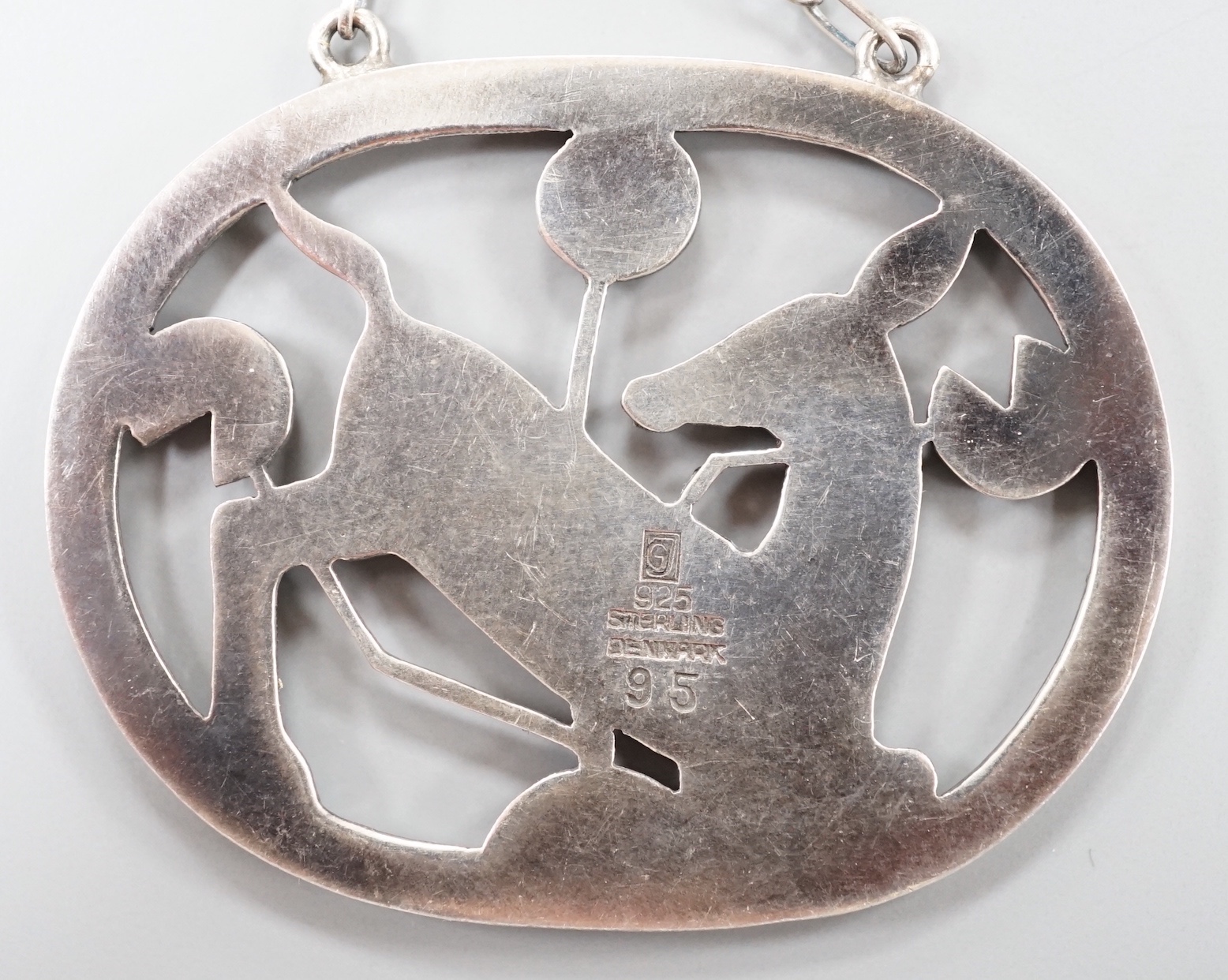 A Georg Jensen sterling 'kneeling deer' oval pendant necklace, no. 95, pendant 42mm, chain 53cm.